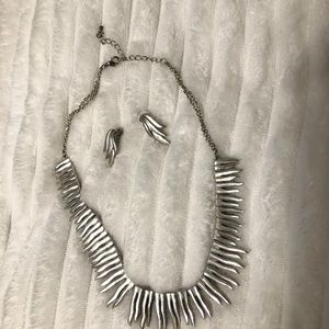 Silver necklace with matching earrings.